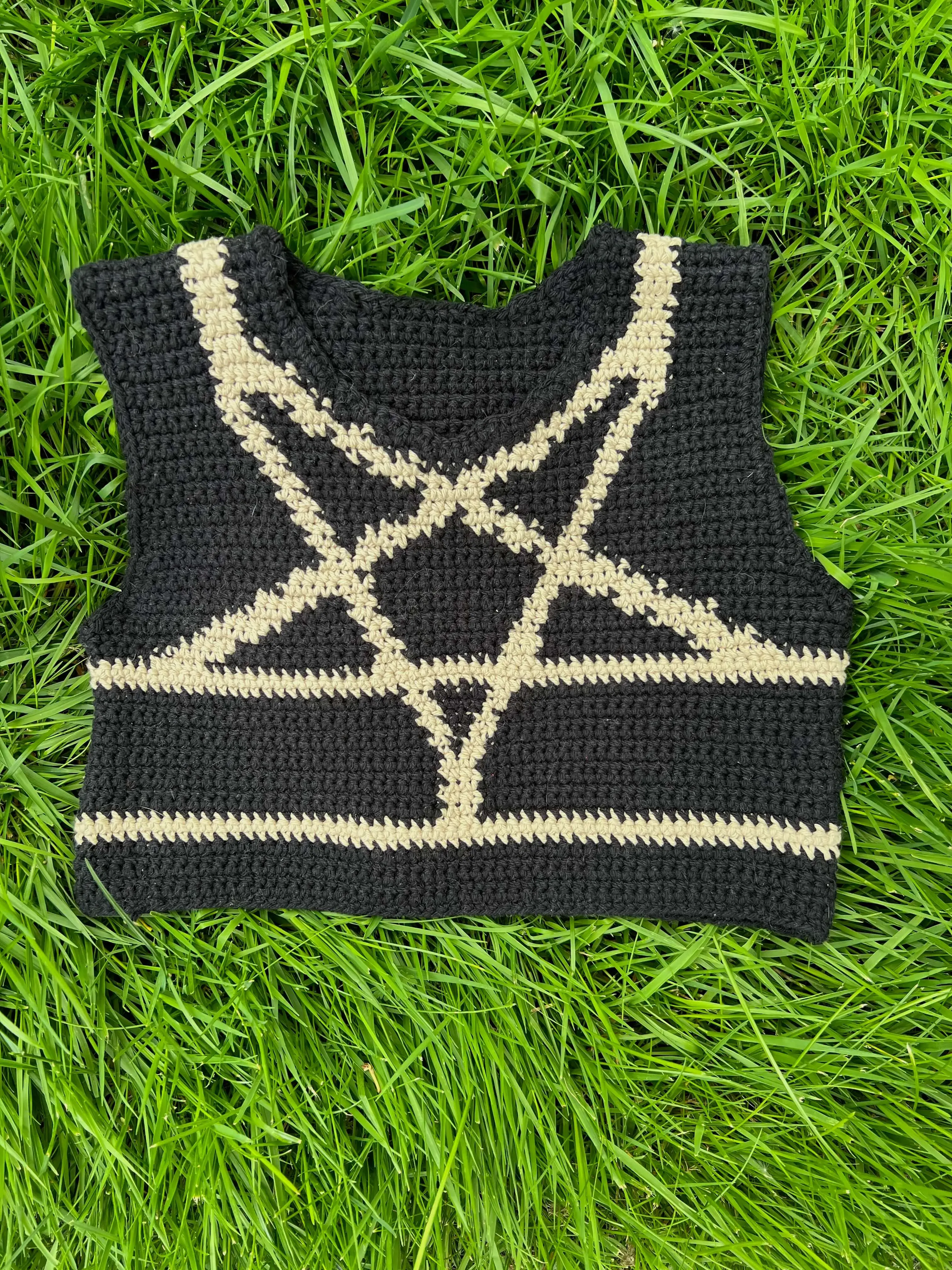 a crochet black binder a tan colorwork design mimicking the shibari inverted star harness