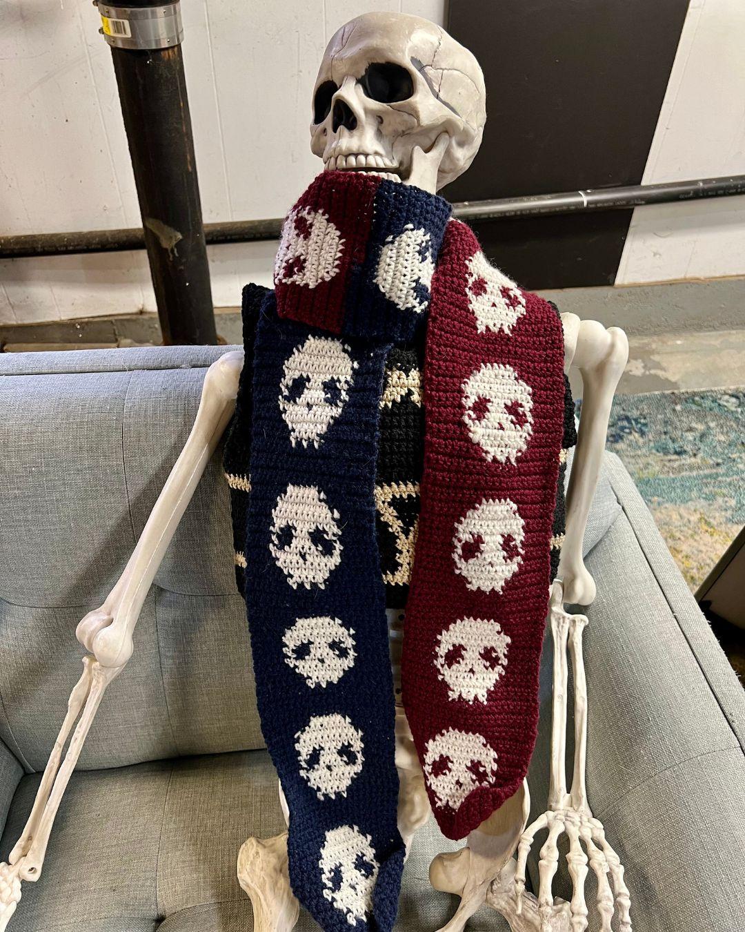 A plastic skeleton wearing the skull scarf wrapped around the neck once