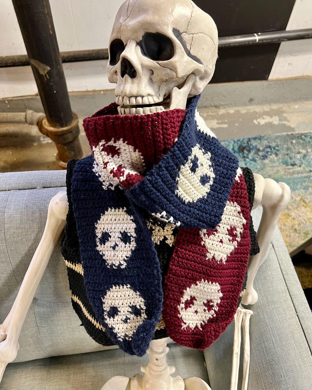 A plastic skeleton wearing the skull scarf wrapped around the neck twice